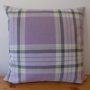 May include: A lavender and white plaid cushion with a subtle green and grey pattern.