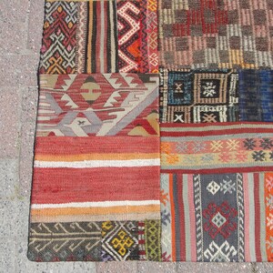 May include: A patchwork rug with a variety of colorful patterns and textures. The rug is made up of different pieces of fabric sewn together, creating a unique and interesting design.
