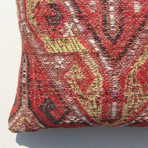 May include: Red, yellow, and black patterned throw pillow with a woven texture.