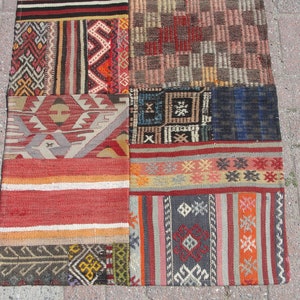 May include: A patchwork rug with a variety of colorful geometric patterns and designs. The rug is made of wool and has a hand-woven texture.