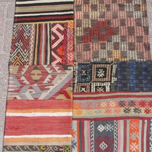 May include: A patchwork rug made of different colored fabrics with geometric patterns. The rug is made up of nine squares, each with a different design. The rug is a mix of red, orange, brown, blue, and white.
