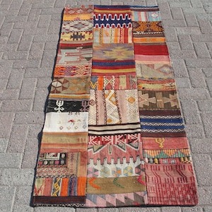 May include: A long, rectangular patchwork rug with a variety of colorful patterns and designs. The rug is made up of many different pieces of fabric sewn together, creating a unique and eclectic look.