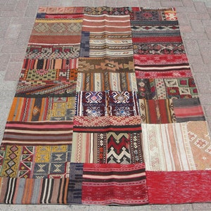 May include: A patchwork rug with a variety of colorful patterns and designs. The rug is made up of different pieces of fabric sewn together, creating a unique and eclectic look.