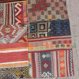 May include: A patchwork rug with a variety of colorful geometric patterns and designs. The rug is made from different pieces of fabric sewn together.
