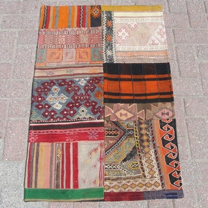 May include: A patchwork rug with a variety of colorful patterns and designs. The rug is made up of different pieces of fabric sewn together, creating a unique and eclectic look.