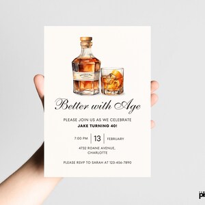 May include: A white invitation card with a watercolor illustration of a bottle of whiskey and a glass of whiskey. The text on the card reads "Better with Age" and includes details for a 40th birthday party.