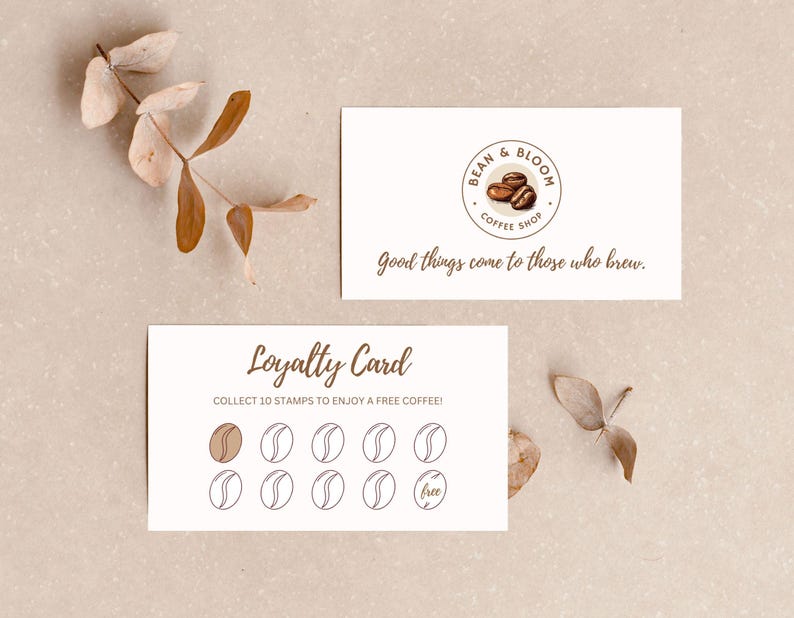 May include: A white loyalty card with a brown coffee bean design. The card says "Loyalty Card" and "Collect 10 stamps to enjoy a free coffee!" There are 10 circles on the card, one of which is filled in with a brown coffee bean. The last circle says "free".