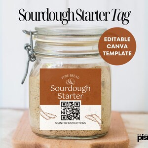 May include: A brown label with the text "Pure Bread Sourdough Starter" and a QR code that says "Scan for Instructions". The label is on a glass jar with a metal lid. The jar is filled with a brown sourdough starter.