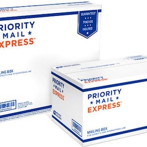 May include: Two white Priority Mail Express boxes with blue and orange lettering. The boxes are labeled "Mailing Box" and have a blue and white sticker that says "Guaranteed, Tracked, Insured".