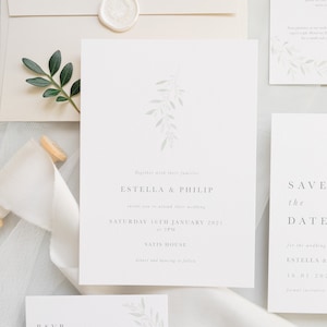 Wedding stationery suite with 5x7 invitation, neutral stone envelope and white wax seal.With accompanying save the date, details and rsvp card. Modern design with pale green watercolour foliage branch. Minimal text below in grey serif font.