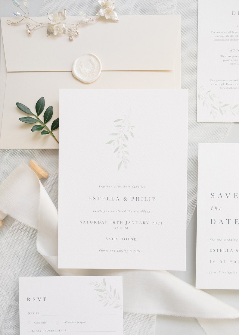 Wedding stationery suite with 5x7 invitation, neutral stone envelope and white wax seal.With accompanying save the date, details and rsvp card. Modern design with pale green watercolour foliage branch. Minimal text below in grey serif font.