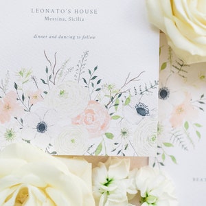 Wedding stationery flat lay with 5x7 invitation and A6 save the date. Both designs feature watercolour floral design with peach roses, white anemone, cream ranunculus and lots of green foliage. Printed on luxury white textured card.