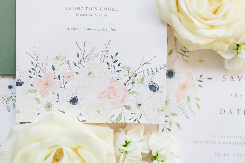 Wedding stationery flat lay with 5x7 invitation and A6 save the date. Both designs feature watercolour floral design with peach roses, white anemone, cream ranunculus and lots of green foliage. Printed on luxury white textured card.