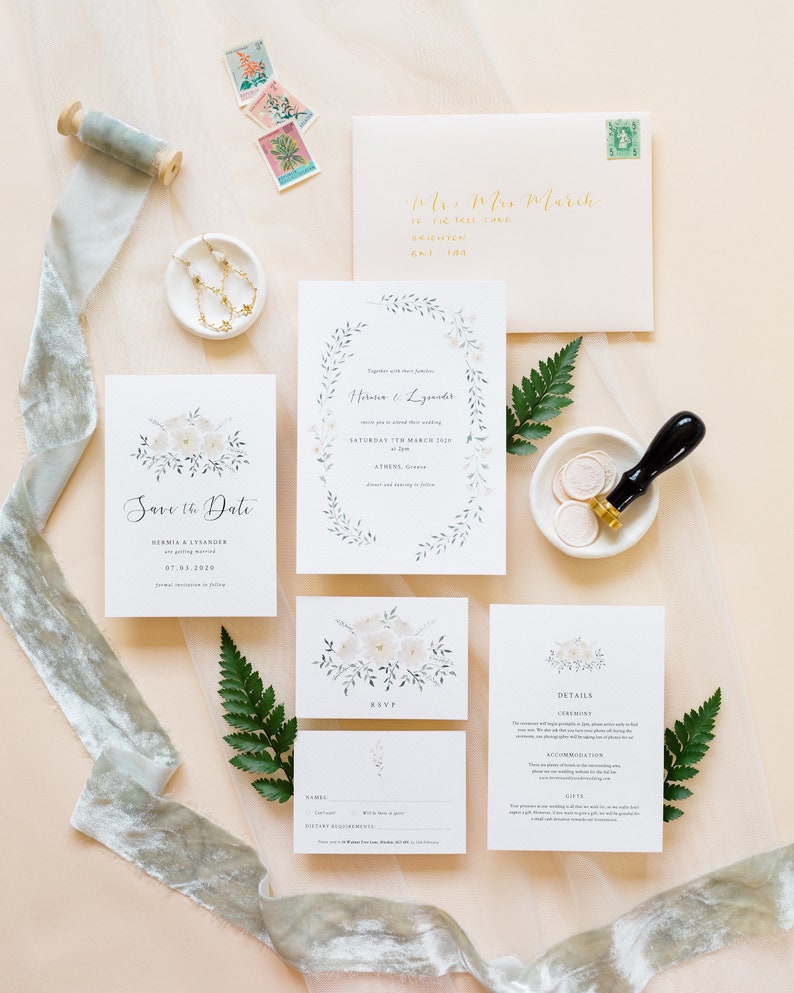 Wedding stationery suite with 5x7 invitation, A6 save the date, details, A7 rsvp card and peach envelope with gold addressing. Design features watercolour foliage and cream flowers in a wreath and bouquet arrangement.