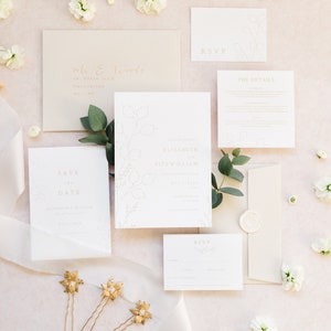 Wedding stationery suite with 5x7 invitation, A6 save the date, details and rsvp with neutral stone envelopes addressed with gold calligraphy and finished with a white wax seal. Minimal design features hand drawn honesty branches in pale gold.