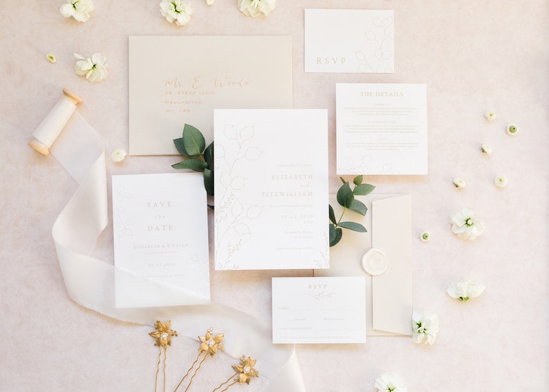 Wedding stationery suite with 5x7 invitation, A6 save the date, details and rsvp with neutral stone envelopes addressed with gold calligraphy and finished with a white wax seal. Minimal design features hand drawn honesty branches in pale gold.