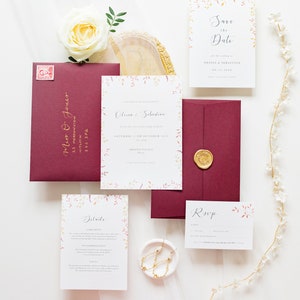 Full stationery suite for an autumn wedding. With invite, save the date, details and RSVP card. All designs feature watercolour autumn leaves in burgundy, burnt orange and gold. Designs are paired with burgundy envelopes with gold calligraphy