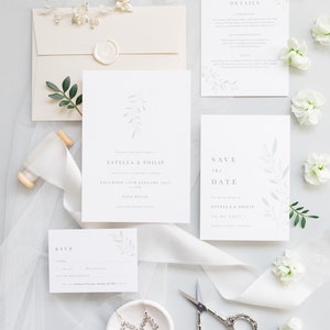 Wedding stationery suite with 5x7 invitation, A6 save the date, details and A7 rsvp card. Envelope is neutral stone with white wax seal. Minimal, modern design features watercolour eucalyptus branch and elegant serif font.