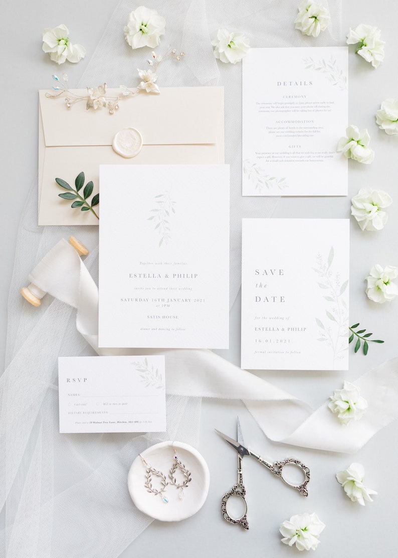 Wedding stationery suite with 5x7 invitation, A6 save the date, details and A7 rsvp card. Envelope is neutral stone with white wax seal. Minimal, modern design features watercolour eucalyptus branch and elegant serif font.