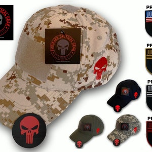 May include: A set of five baseball caps with different camouflage patterns and colors. Each cap features a red, black, or white skull logo with a red, black, or white American flag patch. The text "PUNISHER TACTICAL GEAR" is printed on a tag attached to one of the caps.