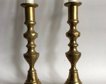 A Victorian pair of brass candlesticks.