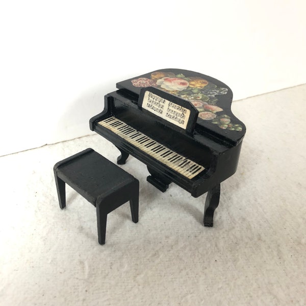 A very pretty Dol toi dolls house wooden grand piano complete with stool, with decoupage flowered decoration.