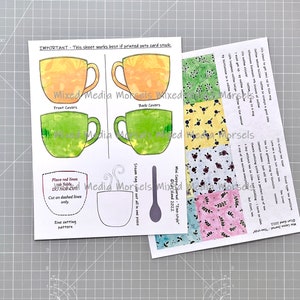 May include: Printable paper craft kit for making a teacup. The kit includes four different patterned paper squares, two teacup templates, a spoon template, and a steam tag template. The instructions include placing red lines, using folds, and cutting on dashed lines only.