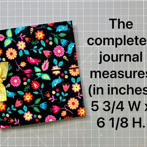 May include: A floral journal with a black background, featuring colorful flowers and birds. The journal is tied with a yellow gingham ribbon. The completed journal measures 5 3/4 inches wide by 6 1/8 inches high.