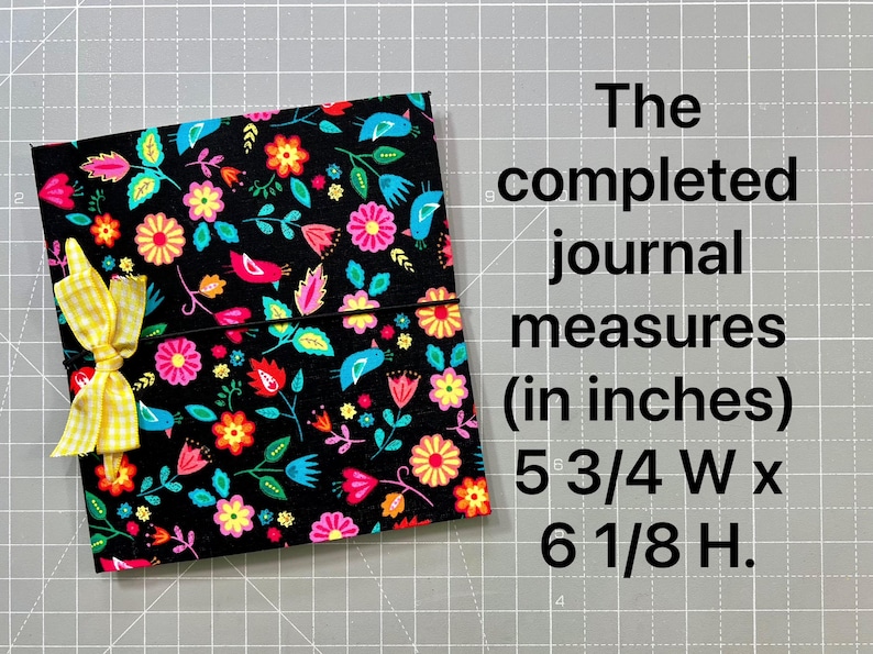 May include: A floral journal with a black background, featuring colorful flowers and birds. The journal is tied with a yellow gingham ribbon. The completed journal measures 5 3/4 inches wide by 6 1/8 inches high.