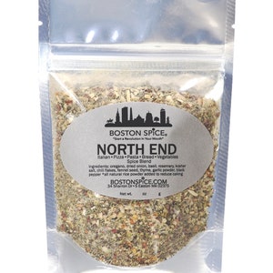 May include: A silver resealable pouch filled with a blend of dried herbs and spices. The label reads "BOSTON SPICE" "Start a Revolution in Your Mouth" "NORTH END" "Italian Pizza Pasta Bread Vegetables Spice Blend" and lists the ingredients. The label also includes the company's website and address: "BOSTONSPICE.COM" "34 Sharron Dr S Easton MA 02375" and "Net wt. oz 6".