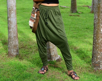 May include: A pair of green, loose-fitting pants with a drawstring waist and a single pocket on the left leg. The pants are made of a soft, comfortable fabric and are perfect for a casual, relaxed look.