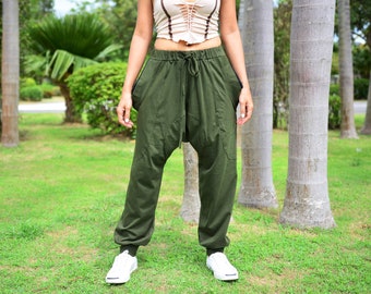 May include: A pair of green, loose-fitting pants with a drawstring waist and a unique, gathered design at the knees. The pants are made of a soft, comfortable fabric and have a relaxed fit.