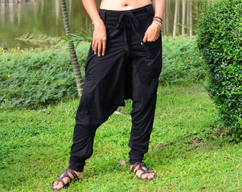 May include: Black harem pants with a drawstring waist and a loose, flowing fit. The pants are made of a soft, comfortable fabric and have a unique, stylish design.