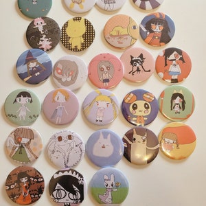 May include: A collection of 20 colourful round pins featuring various cartoon characters and designs. The pins are arranged in a circular pattern on a white surface.