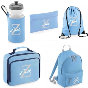May include: A blue personalised school set with the name "Zack" on each item. The set includes a backpack, lunch bag, water bottle, pencil case and drawstring bag.