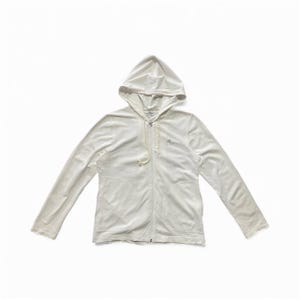May include: A white hooded zip-up sweatshirt with long sleeves. The sweatshirt has a drawstring at the hood and a small logo on the chest. The fabric appears to be soft and comfortable.