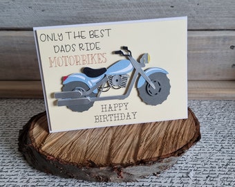 May include: A yellow card with the text "Only the best dads ride motorbikes" and a blue and gray paper cut-out of a motorcycle. The card also says "Happy Birthday".