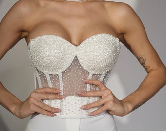 Parelwit korset. Bruidskorset doorschijnend bovenborstkorset strapless, concertoutfit.