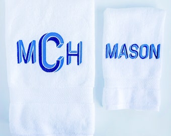 May include: Two white towels with blue embroidered lettering. One towel has the initials "MCH" and the other towel has the name "MASON".
