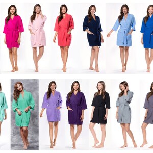 May include: A collection of 18 women's robes in various colors, including white, pink, red, blue, green, purple, black, and gray. The robes are made of a soft, comfortable material and feature a classic kimono style.