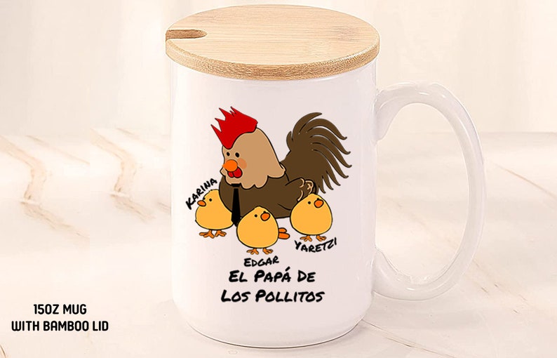 May include: White ceramic mug with a bamboo lid. The mug features a cartoon rooster with three chicks, and the text "El Pap&aacute; de Los Pollitos". The mug is 15oz.