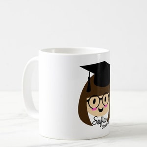 May include: White ceramic mug featuring a cartoon illustration of a graduate with brown hair, glasses, and a black graduation cap. The mug has the name "Sofia" and "Class of" printed on it.