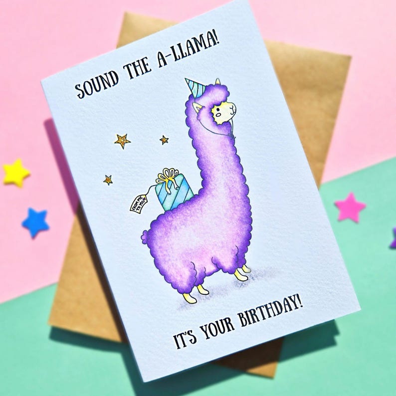 Puede incluir: Una tarjeta de cumplea&ntilde;os con una llama morada que lleva un gorro de fiesta y lleva un regalo. La tarjeta dice "Sound the A-llama! It's your birthday!"