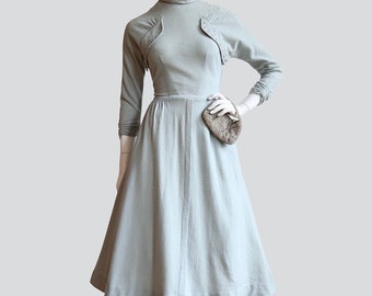 Vintage early 1950’s | Medium | Elegant light sage, wool jersey dress decorated with rhinestones, full skirt with pockets.