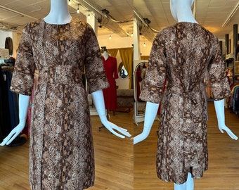 Vintage 1960's | Medium | Python print dress with belted waist and flyaway panel skirt.