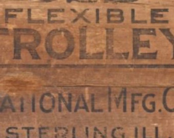 May include: A vintage wooden crate with the text "52B FLEXIBLE TROLLEY NATIONAL MFG.C STERLING ILL." printed on it. The crate is brown and has a rustic look. This is a decoupage paper for crafts.