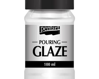 May include: A white plastic bottle with a black lid and label. The label says "pentart POURING GLAZE 100 ml".