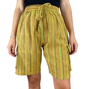 May include: Yellow, brown, and green striped shorts with a drawstring waist and cargo pockets. The shorts have a relaxed fit and are made of a lightweight fabric. The shorts are knee-length.