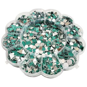 May include: A clear, flower-shaped container filled with small, reflective, mirror-like pieces in various shapes, including squares, triangles, and circles. The pieces have a teal backing. The container is divided into multiple compartments.