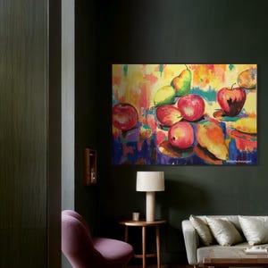 May include: A colorful abstract painting of a still life with apples, pears, and a banana on a yellow background. The painting is framed and hanging on a dark green wall in a living room.